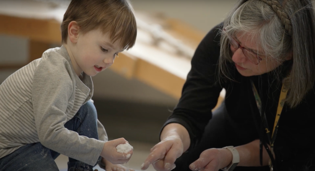 Therapist working with a child on a therapy exercise.