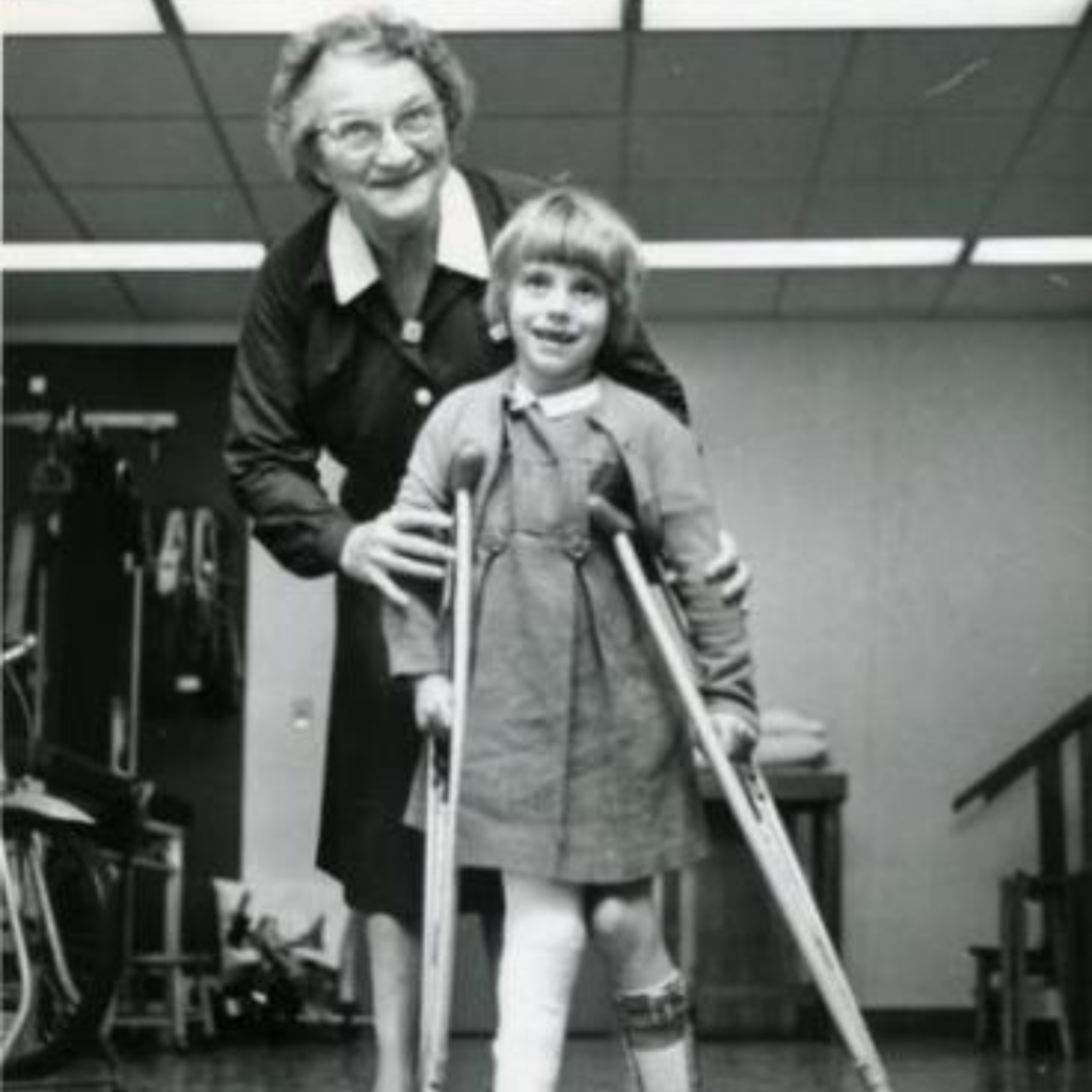 Old photo of woman and a girl with crutches.