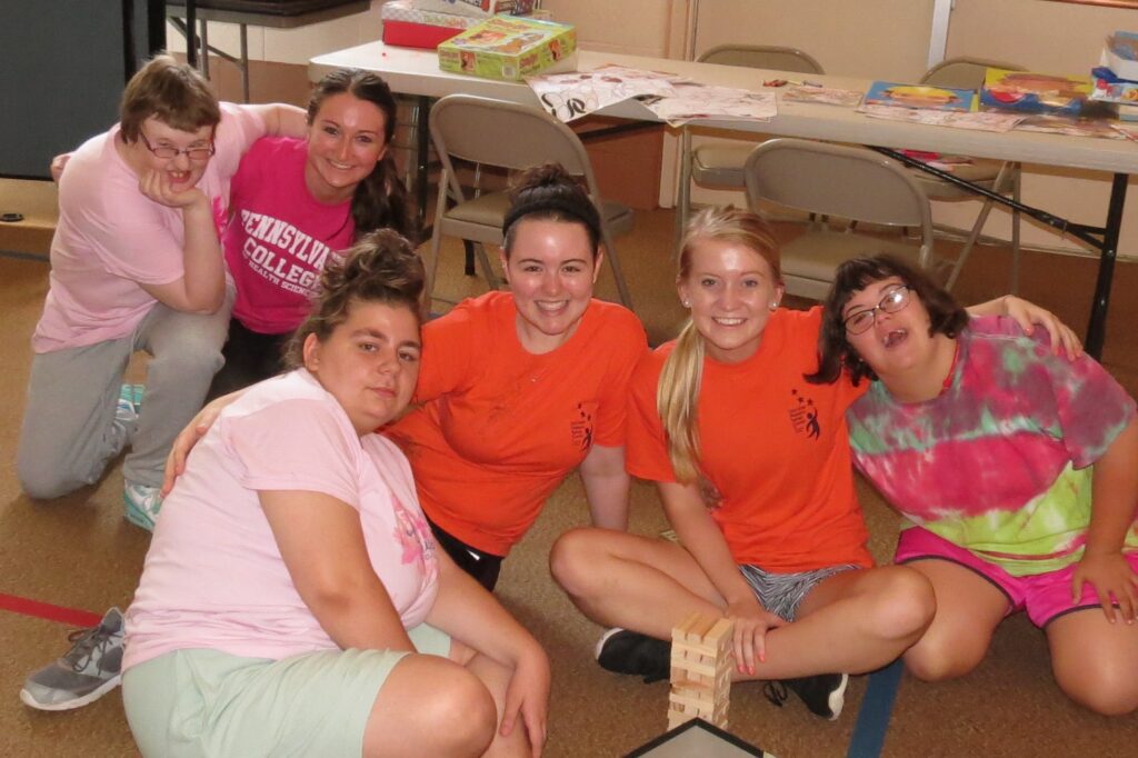 group of girls in camp shirts sitting on floor