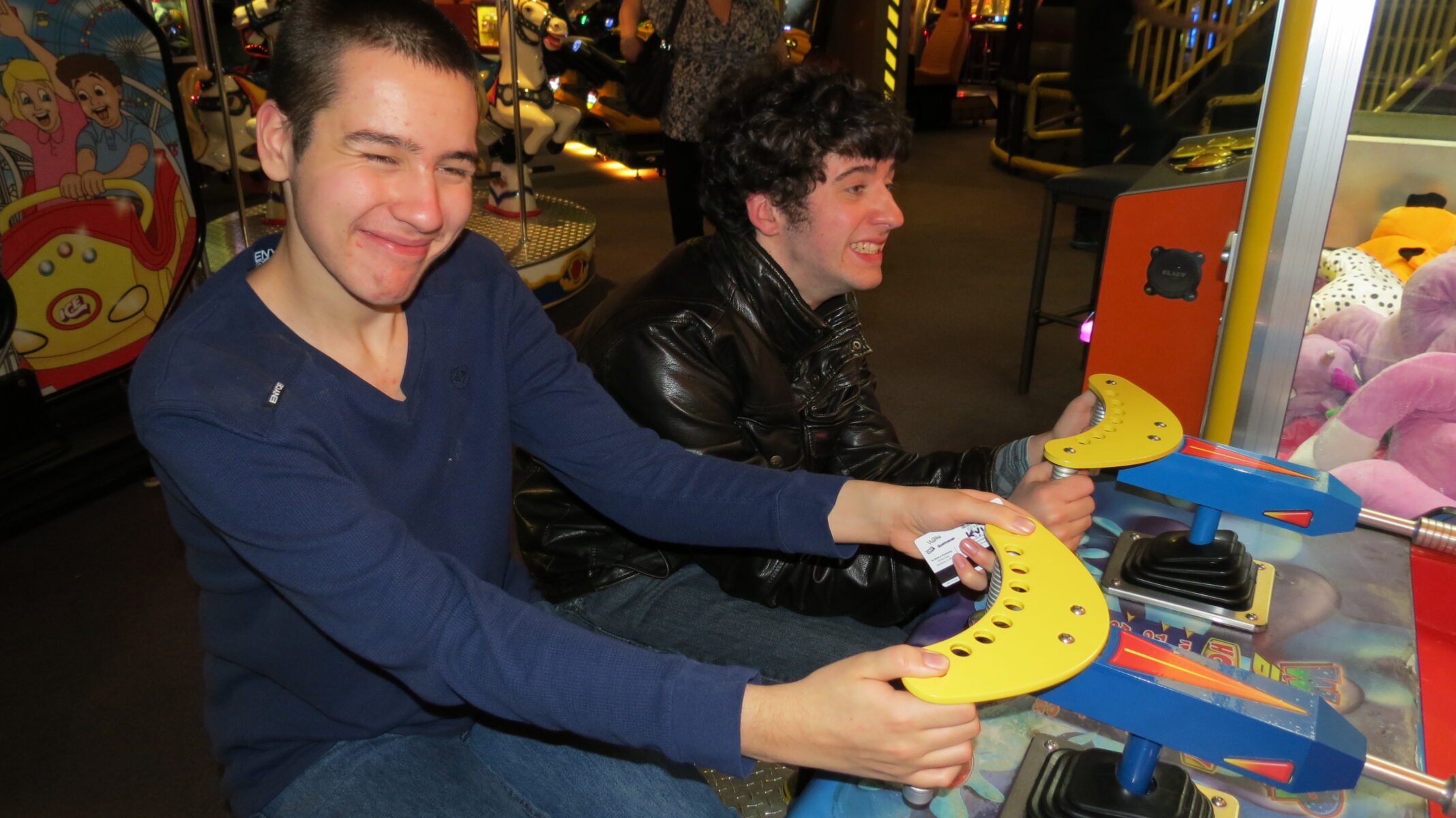 two boys playing an arcade game