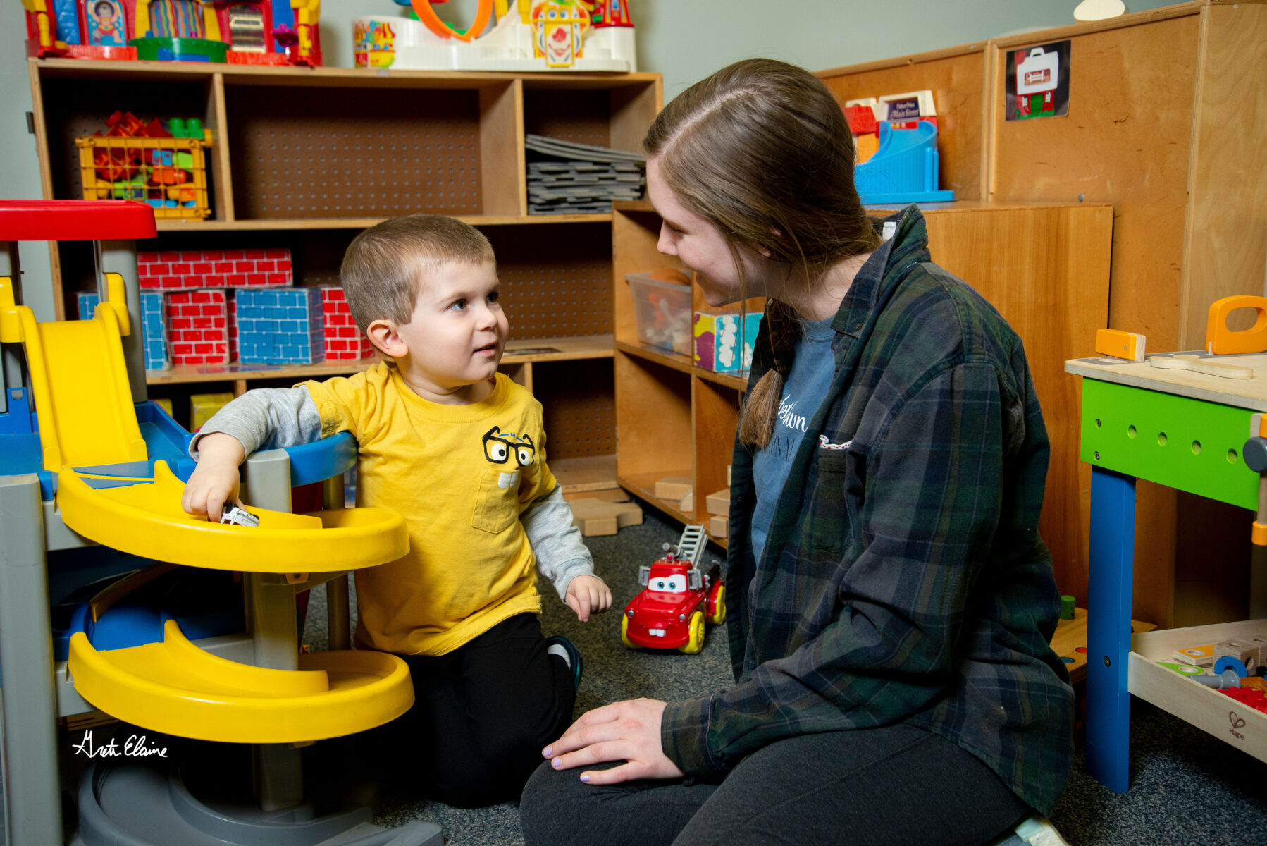 teacher and student engaged in play in the classroom