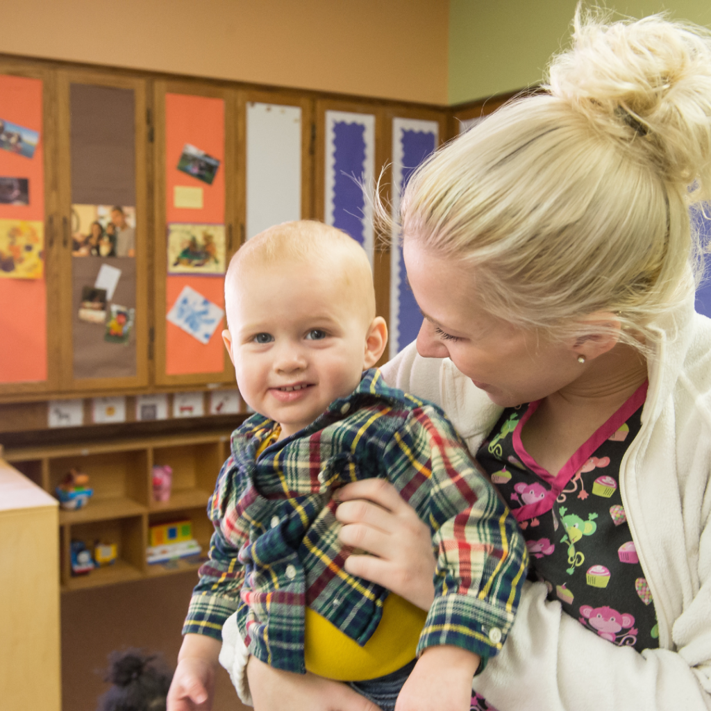 woman looking at a smiling baby